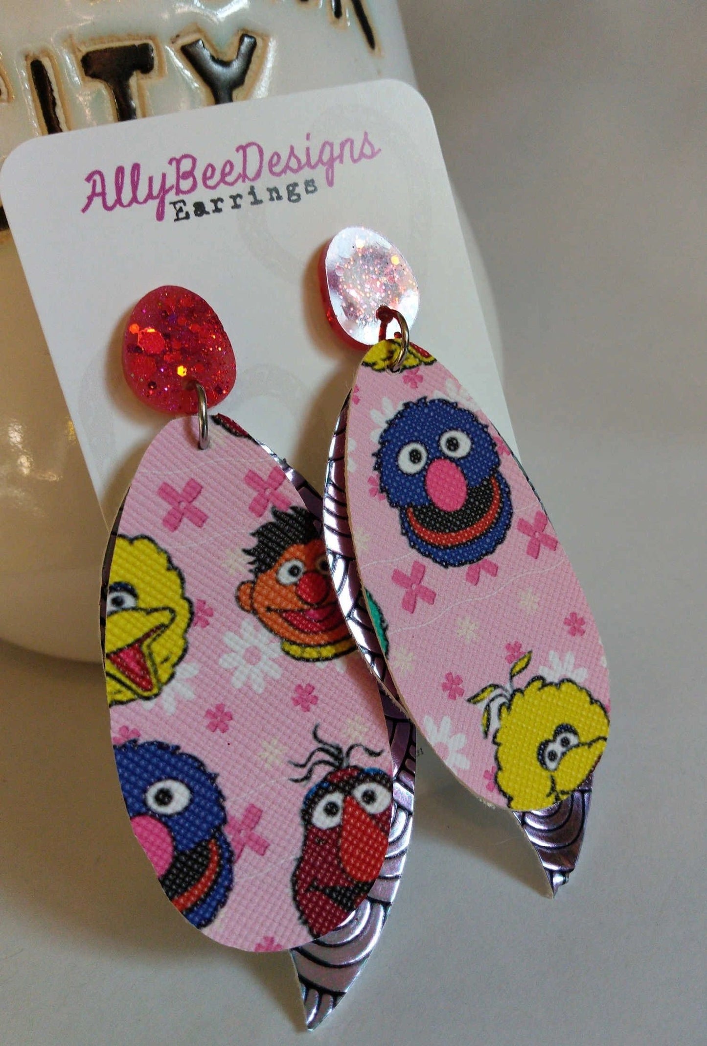 Pink character dangle earrings